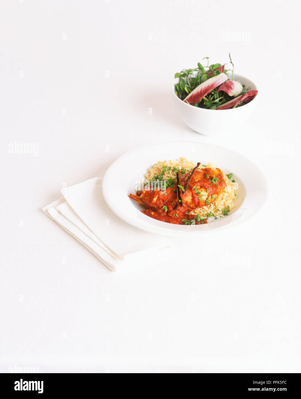 Moroccan rabbit stew served with bowl of salad Stock Photo - Alamy