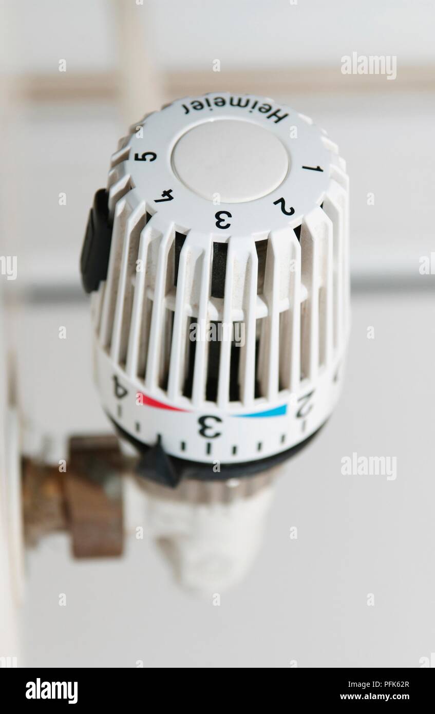 Thermostatic valve on radiator showing numbers and German text, closeup Stock Photo Alamy