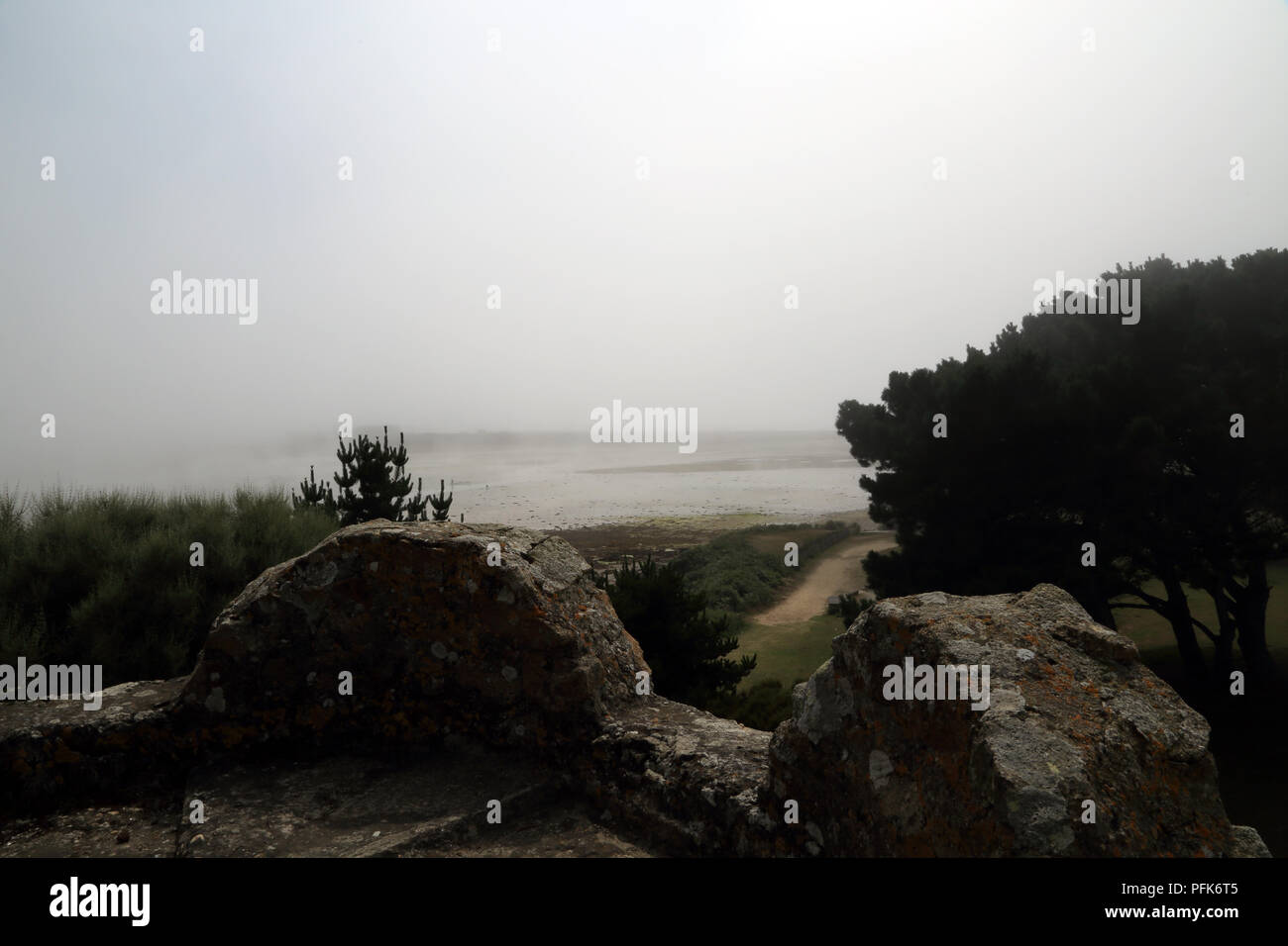 Mist and view from Ilot Sainte Anne, St Pol de Leon, Finistere, Brittany, France Stock Photo