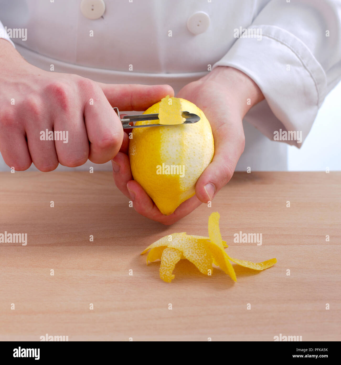 https://c8.alamy.com/comp/PFKA5K/hand-holding-peeler-and-lemon-peeling-off-lemon-zest-close-up-PFKA5K.jpg