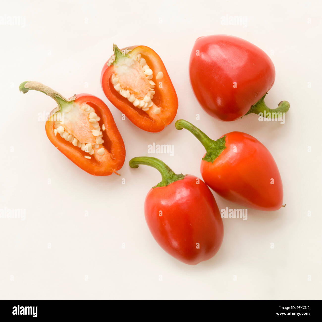 Red cherry bomb peppers, whole and sliced, close-up Stock Photo - Alamy