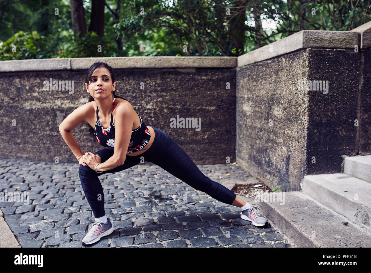 Latina Hispanic Woman Stretches Before A Workout Stock Photo - Alamy