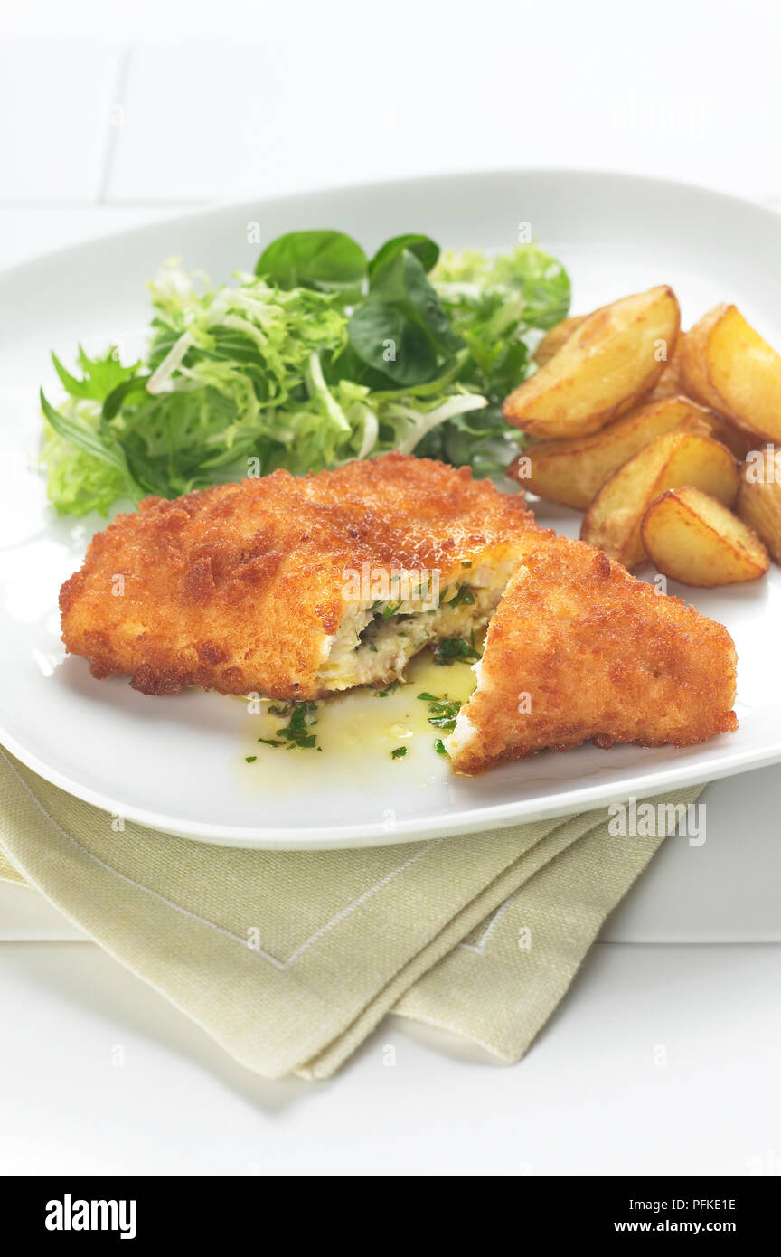 Chicken Kiev, stuffed with herb and butter sauce, served with roast
