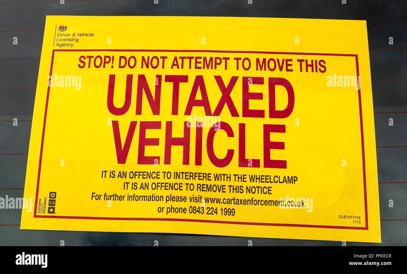 A Untaxed Vehicle notice stuck on the windscreen of an untaxed car Stock Photo