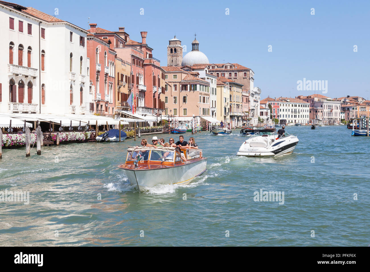 Tour group in a water taxi sightseeieing on the Grand Canal, Cannaregio, Venice, Veneto, Italy in summer sunshine. Tourism, tourists, transport, boat Stock Photo