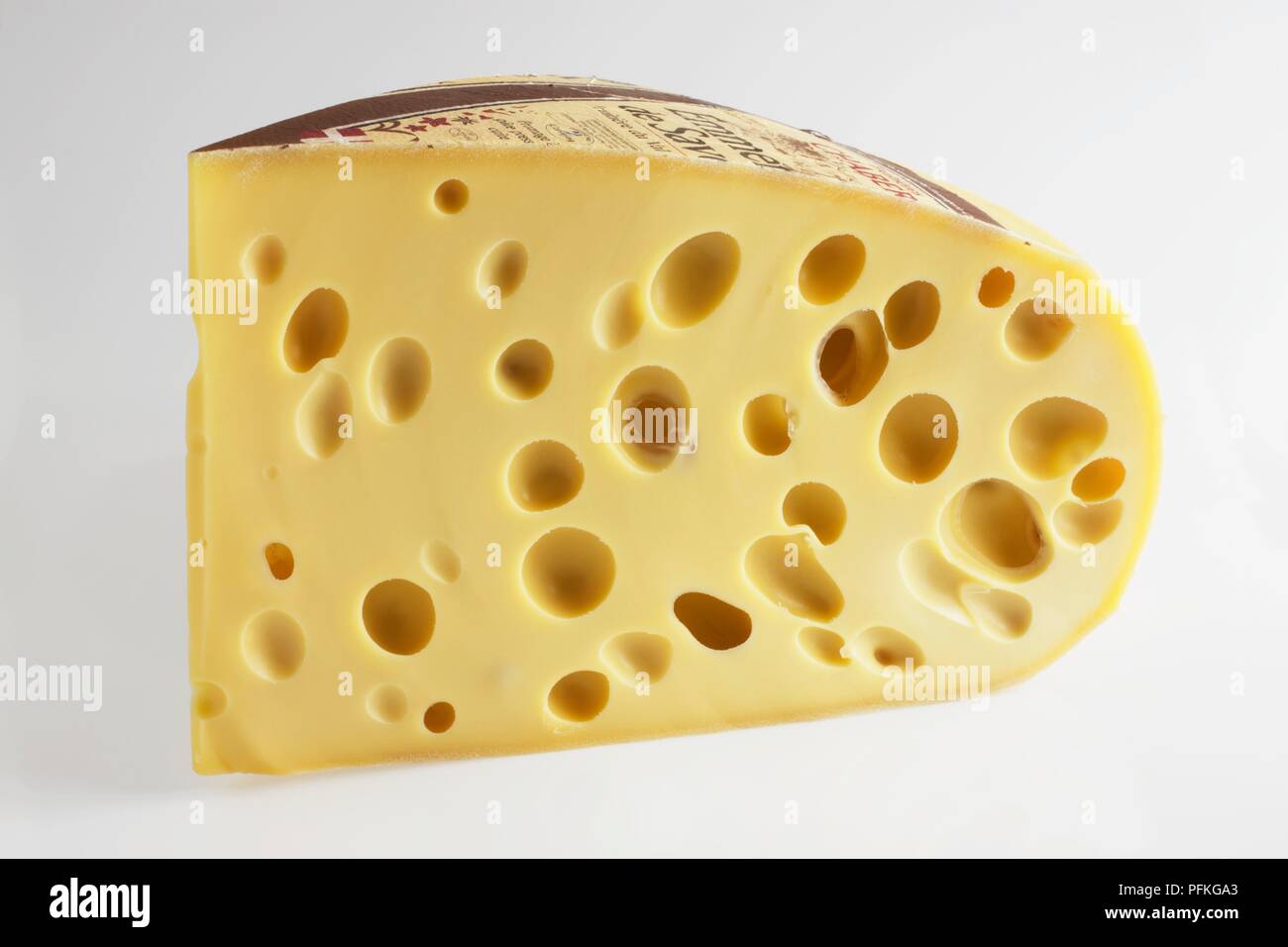 Slice of French Emmental de Savoie cow's milk cheese showing holes