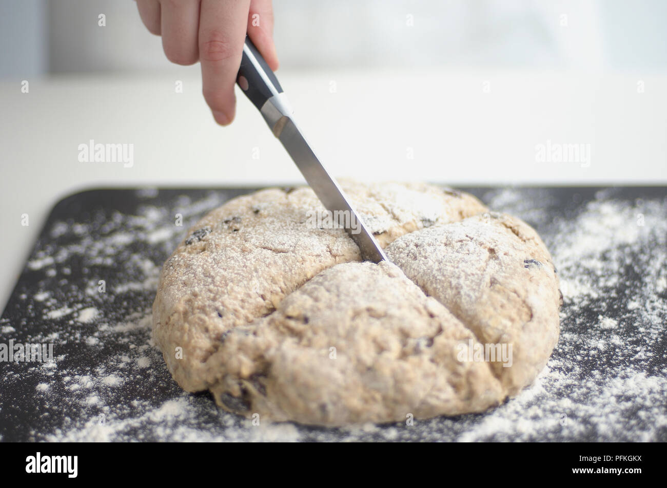 Using small kitchen knife to score soda bread Stock Photo Alamy