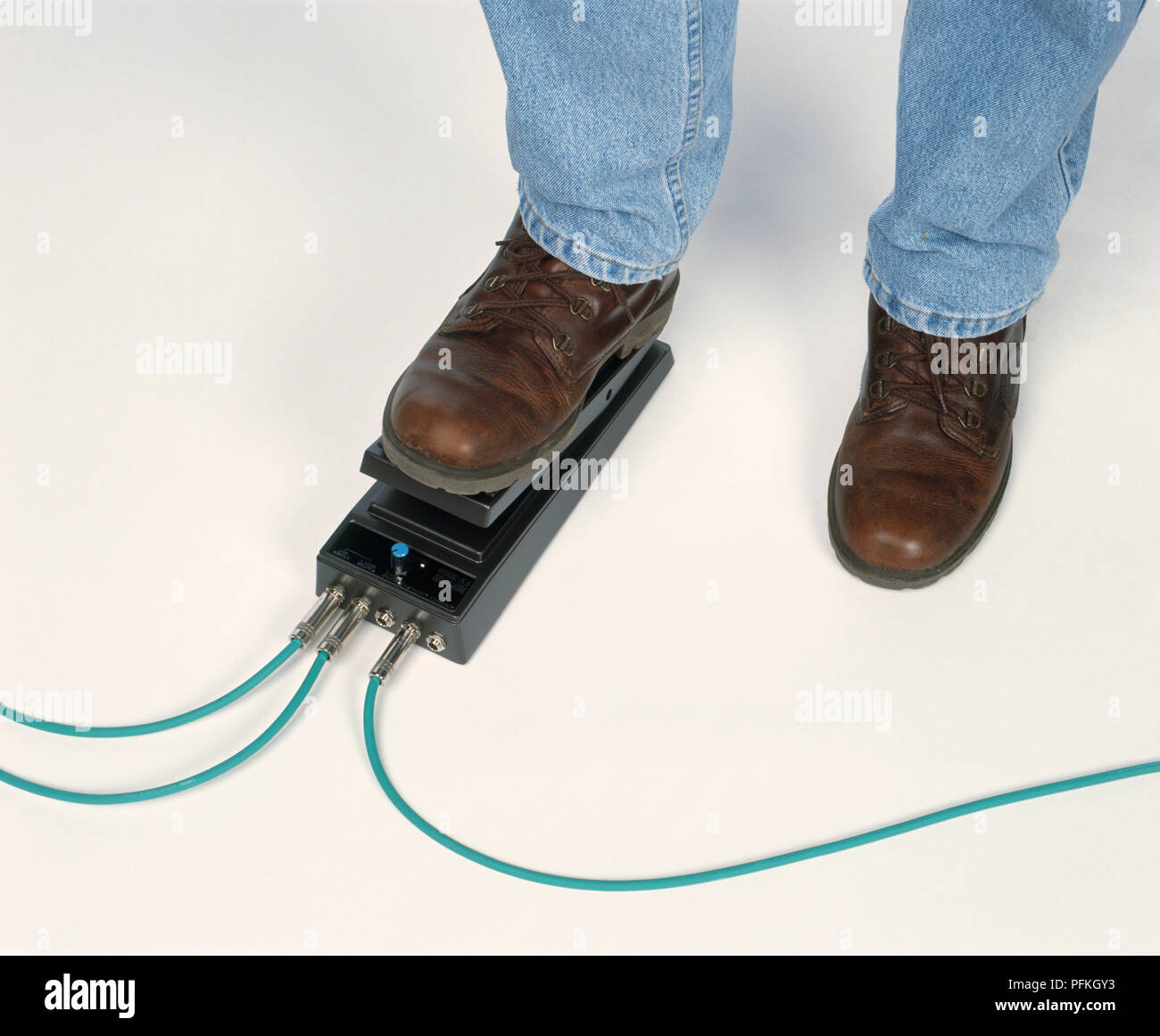 Foot on electric guitar volume pedal, closeup Stock Photo Alamy