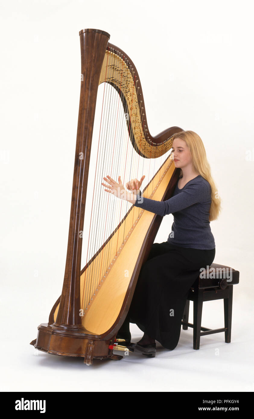 https://c8.alamy.com/comp/PFKGY4/teenage-girl-playing-harp-side-view-PFKGY4.jpg