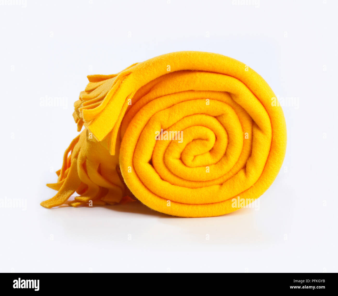 Rolled up yellow blanket Stock Photo