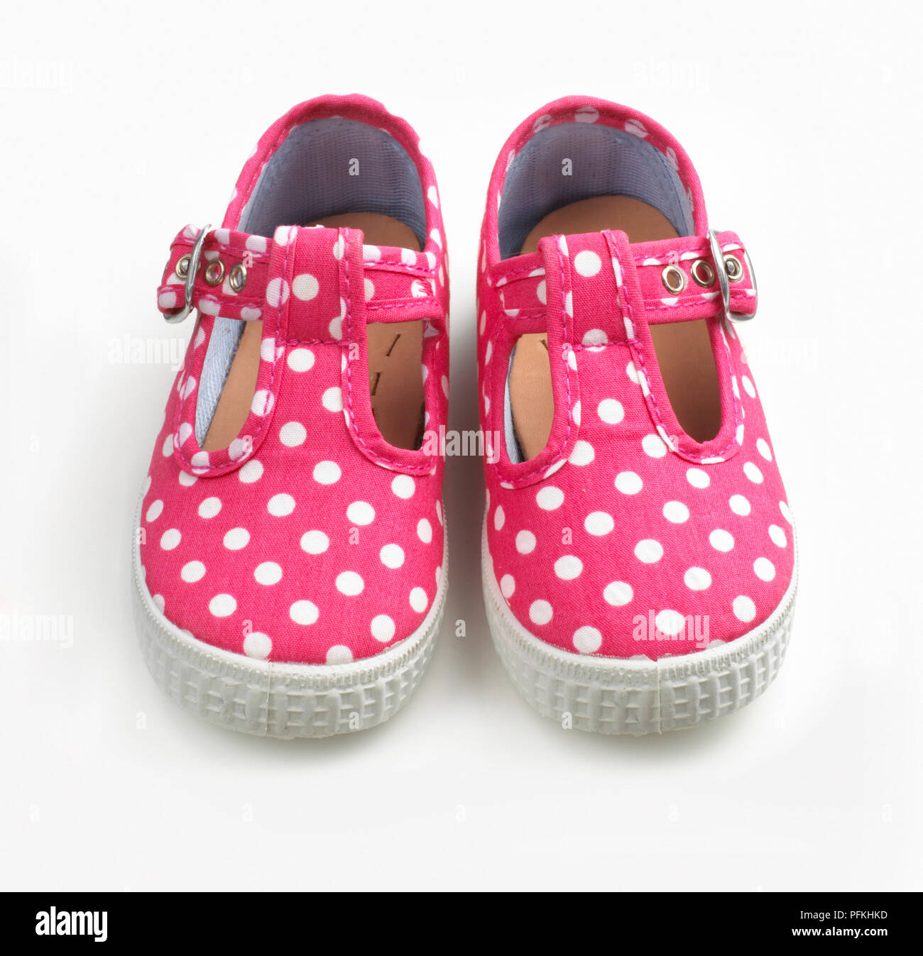 Baby shoes, pink with white spots, close-up Stock Photo - Alamy