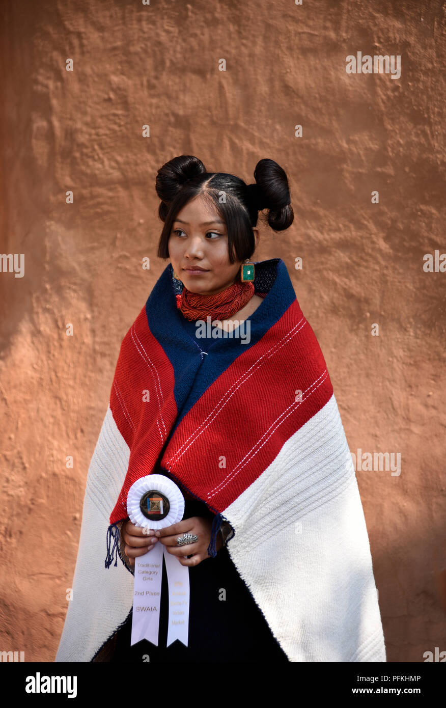 A young Native-American (Hopi) woman wearing traditional Hopi clothing, jewelry and hairstyle at the Santa Fe Indian Market. Stock Photo