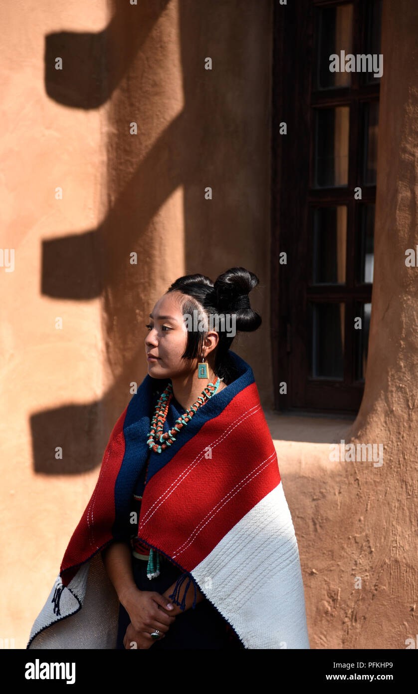 A young Native-American (Hopi) woman wearing traditional Hopi clothing, jewelry and hairstyle at the Santa Fe Indian Market. Stock Photo