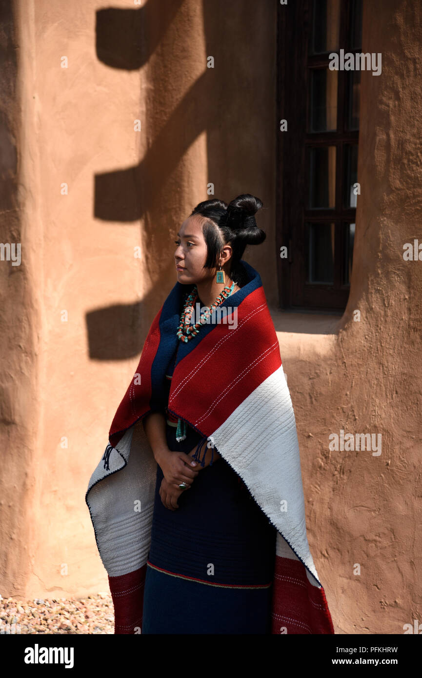 A young Native-American (Hopi) woman wearing traditional Hopi clothing, jewelry and hairstyle at the Santa Fe Indian Market. Stock Photo