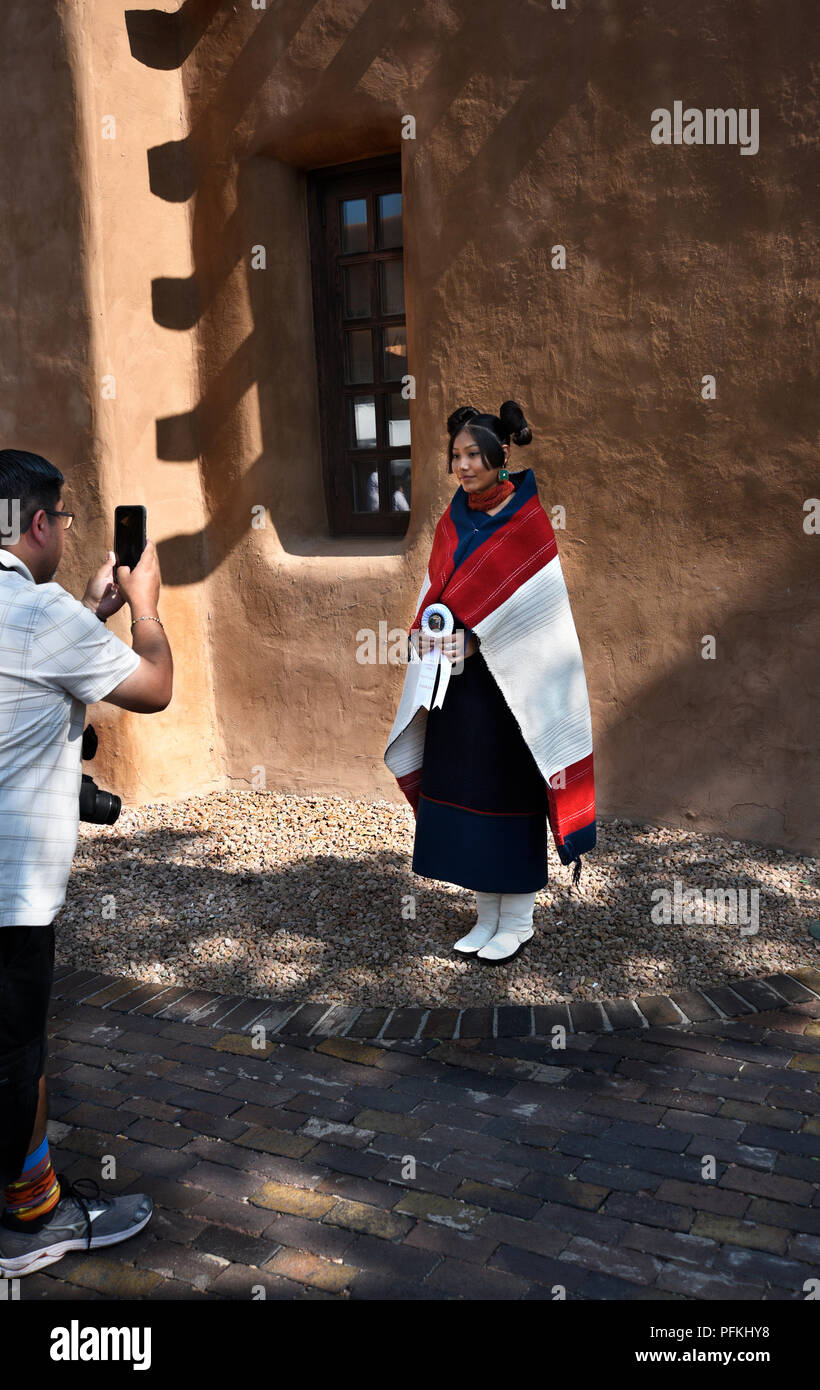 A young Native-American (Hopi) woman wearing traditional Hopi clothing, jewelry and hairstyle at the Santa Fe Indian Market. Stock Photo