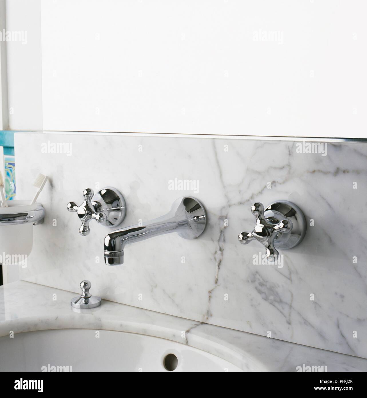 Silver Fittings In Marble Surface Over Bathroom Sink