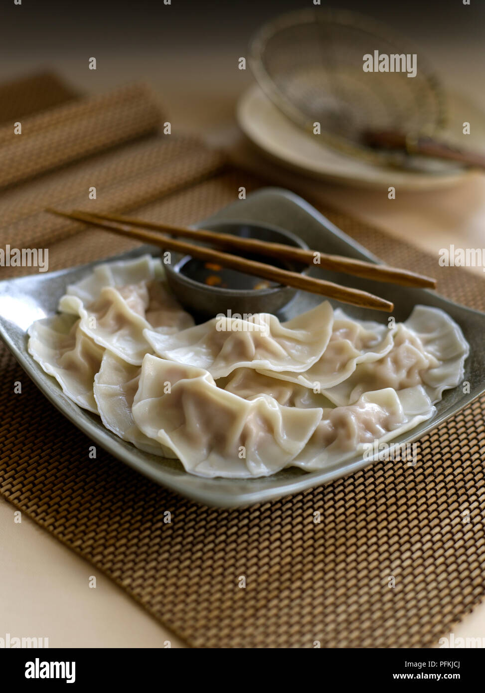 Zhong shui jiao, crescent dumplings, served on plate with soy dipping