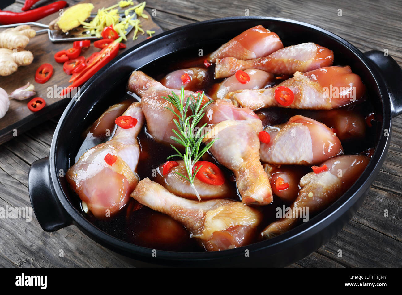 raw chicken drumsticks marinated with homemade spicy teriyaki sauce in