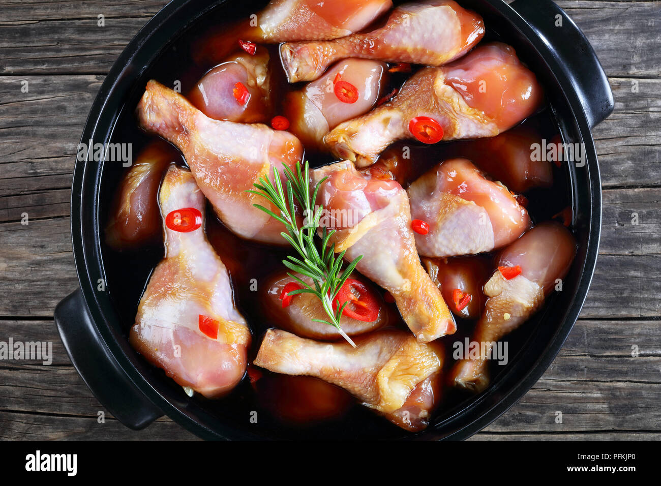 raw chicken drumsticks marinated with homemade spicy teriyaki sauce in