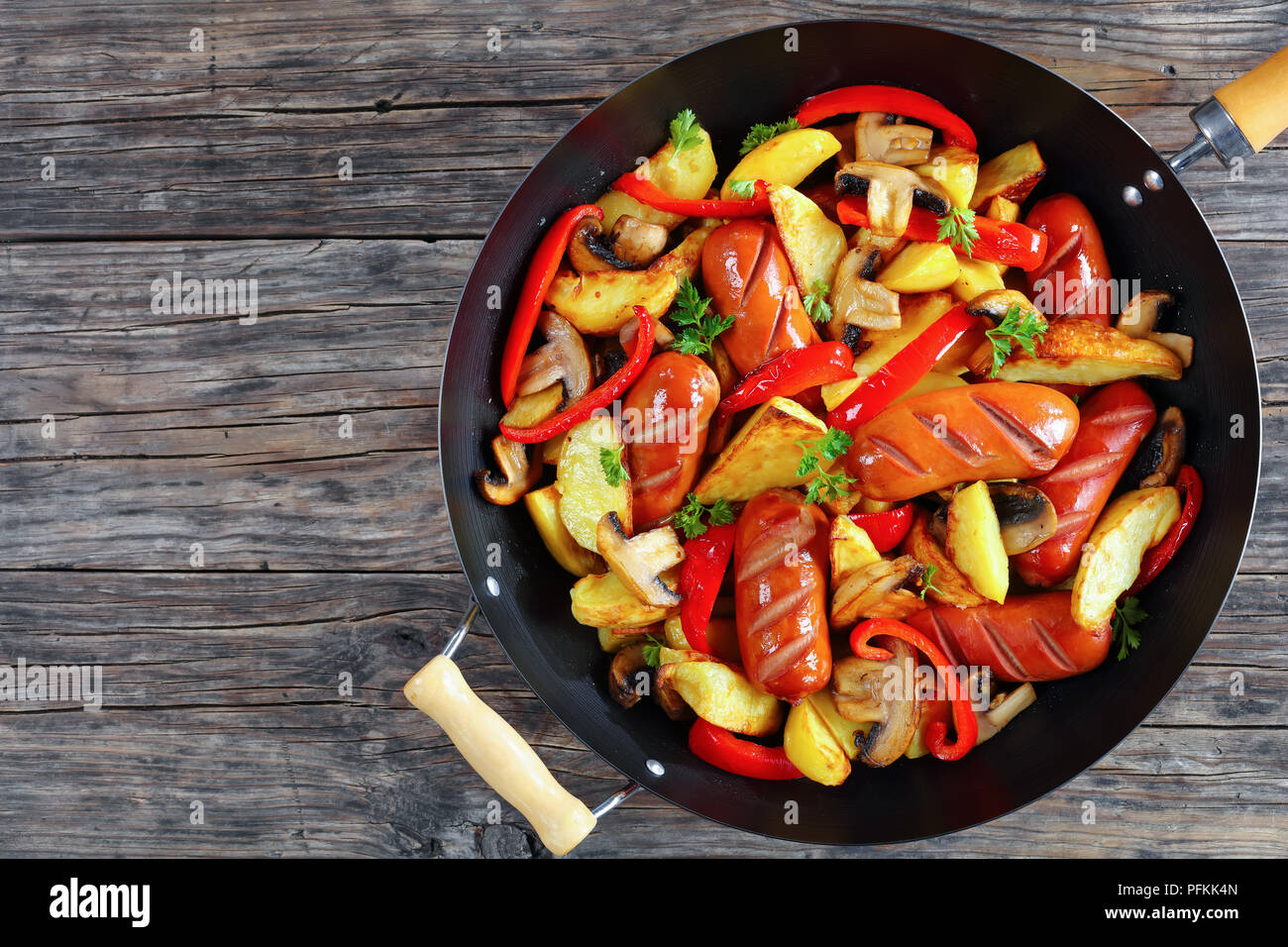 Delicious Grilled Sausages With Potato Wedges Red Bell Pepper Pieces Mushrooms And Parsley In A Frying Pan View From Above Close Up Stock Photo Alamy