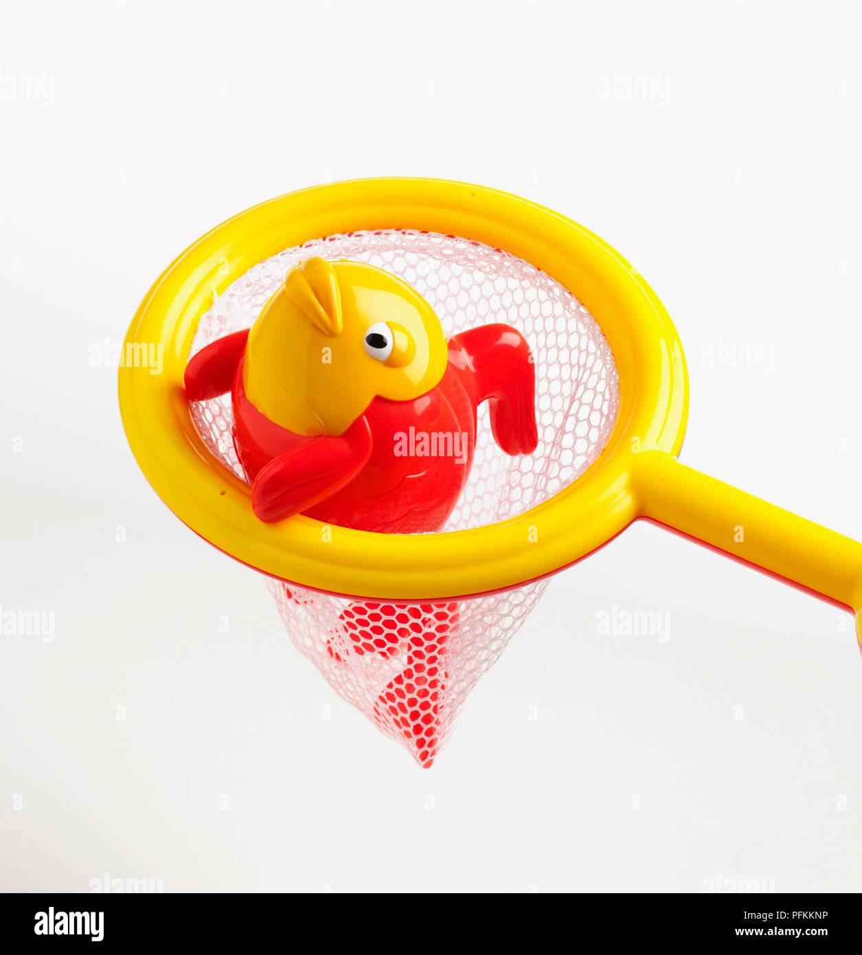 https://c8.alamy.com/comp/PFKKNP/red-and-yellow-plastic-fish-shaped-clockwork-bath-toy-in-fishing-net-PFKKNP.jpg