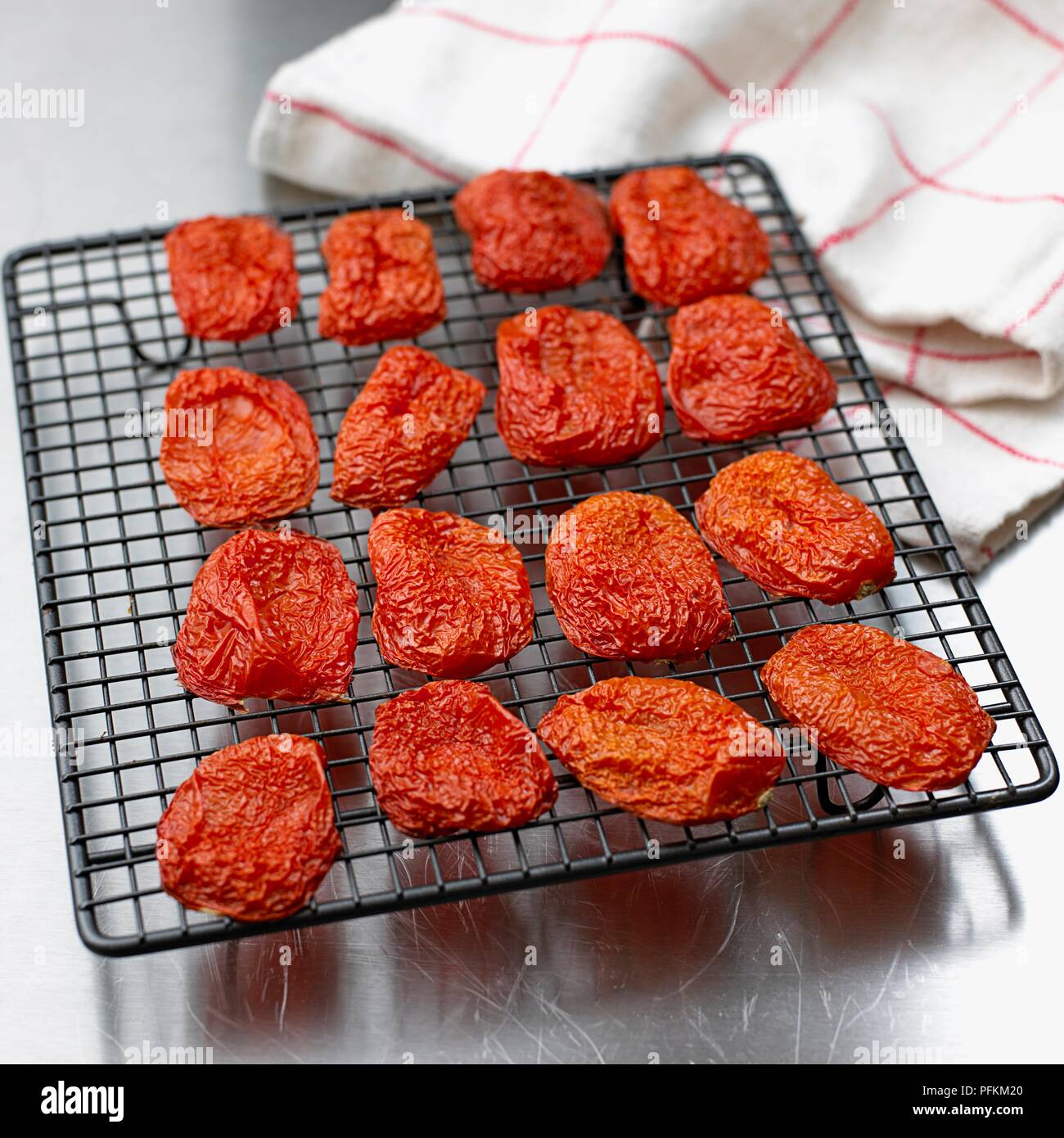 Roasted tomatoes on wire rack Stock Photo