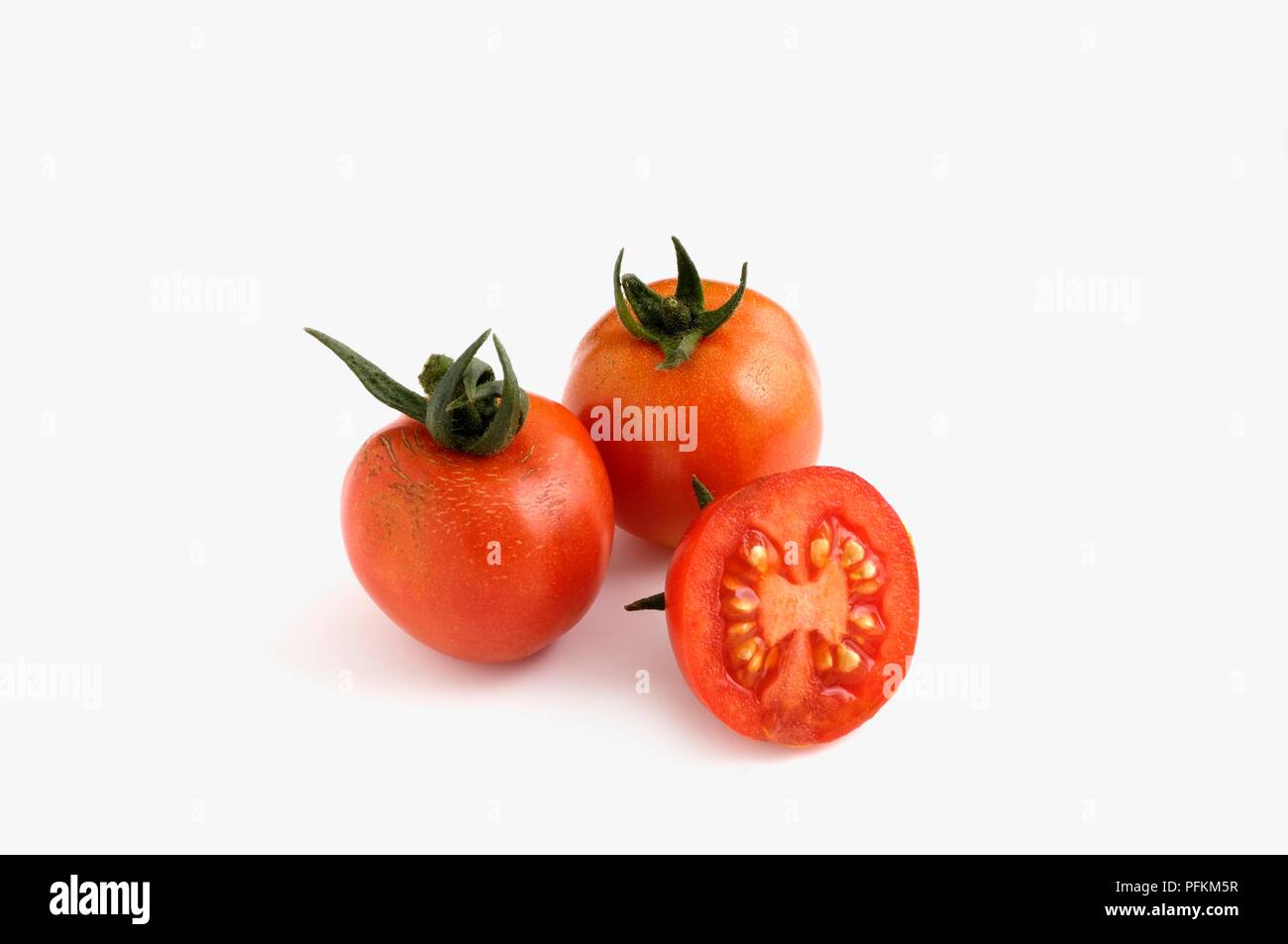 Whole and sliced German Gardener's Delight tomatoes Stock Photo
