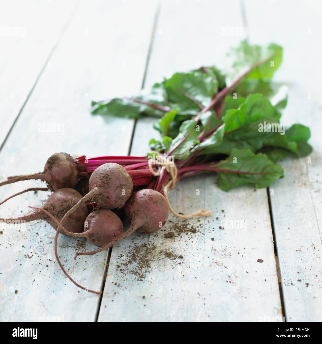 Bunch of freshly picked beetroot on wooden table Stock Photo