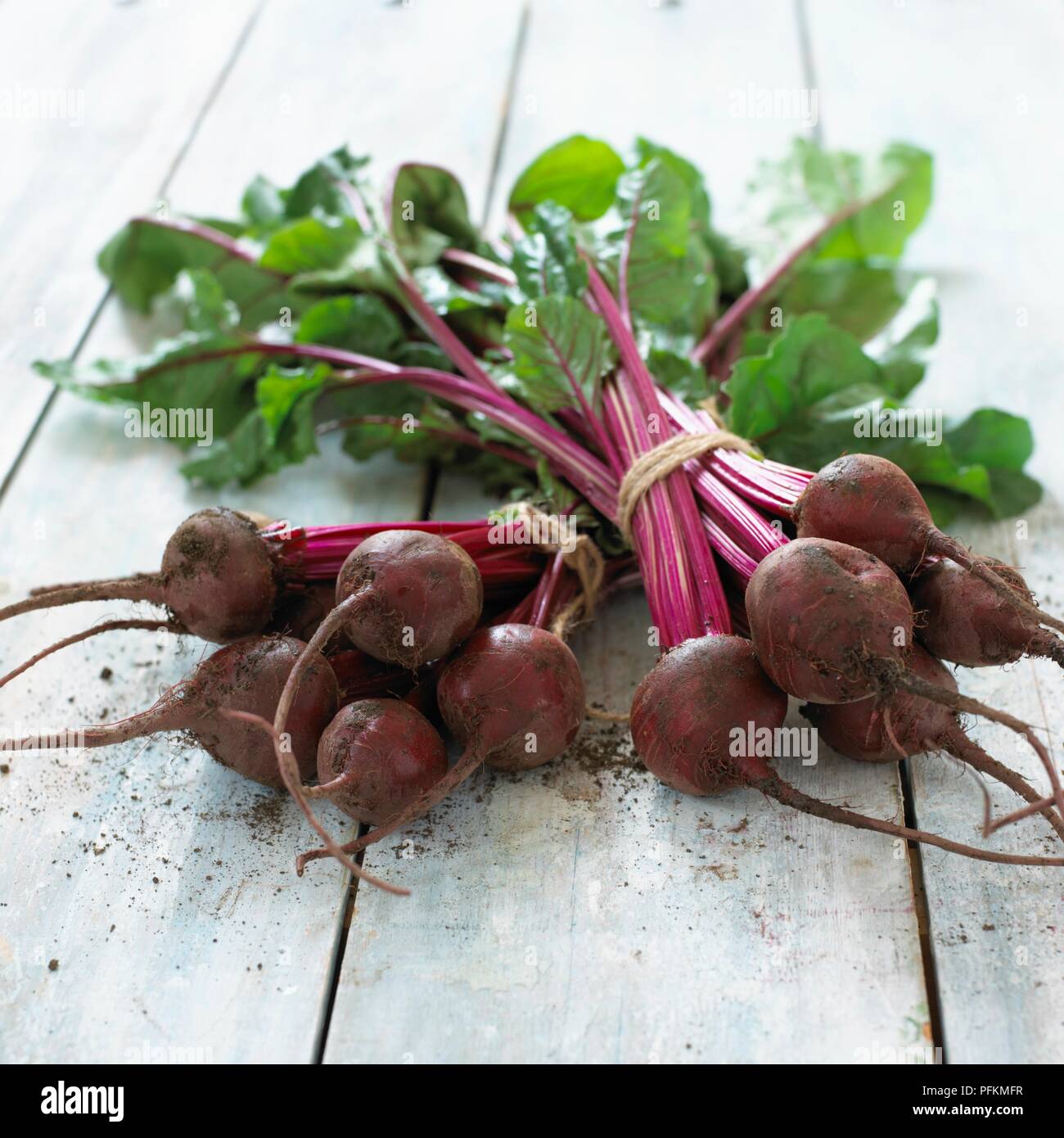 Freshly picked bunches of beetroot on wooden table Stock Photo