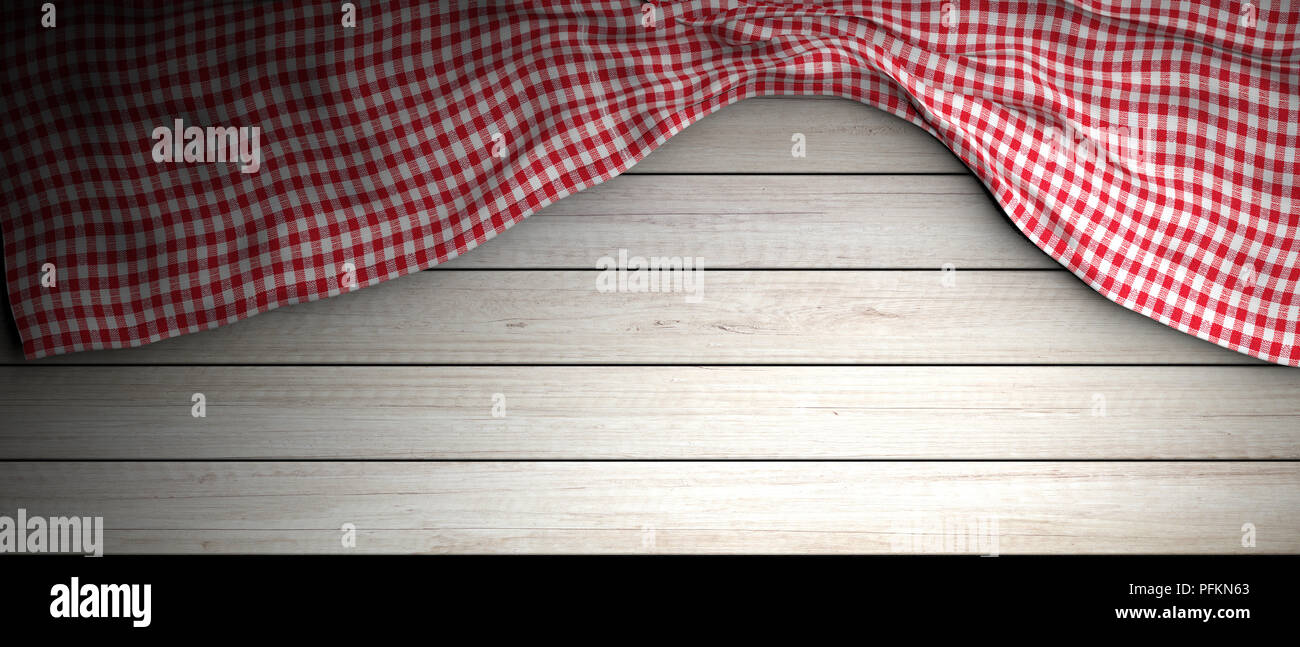 Red and white checkered picnic tablecloth on white wooden background