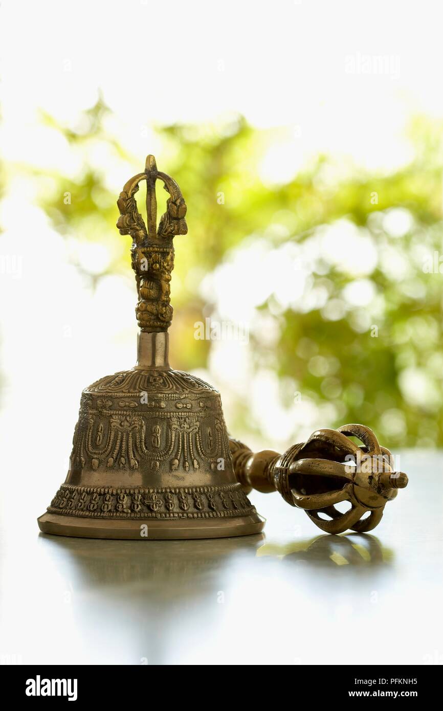 Brass bell and vajra on table Stock Photo