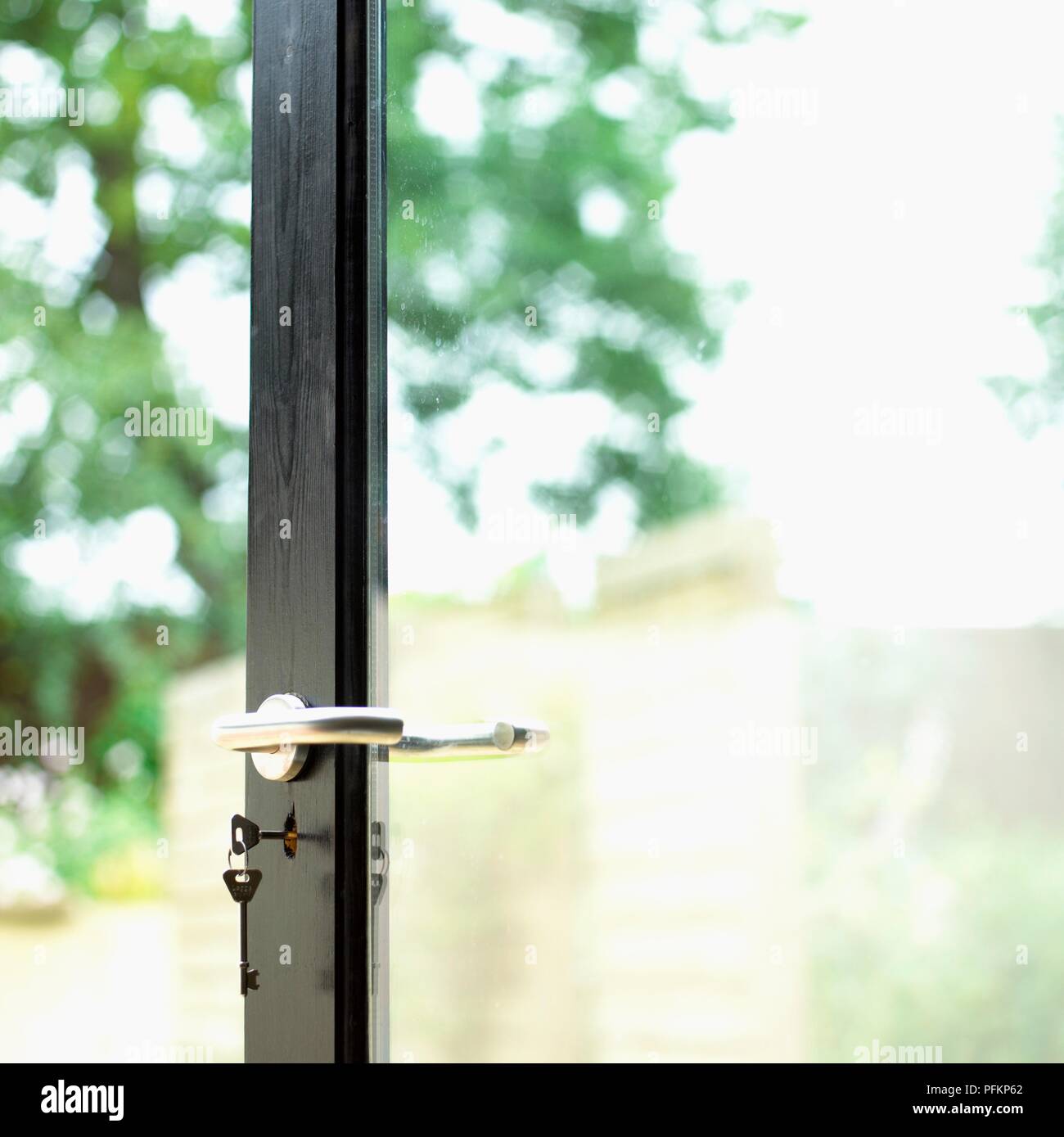 Patio door with key in lock, closeup Stock Photo Alamy