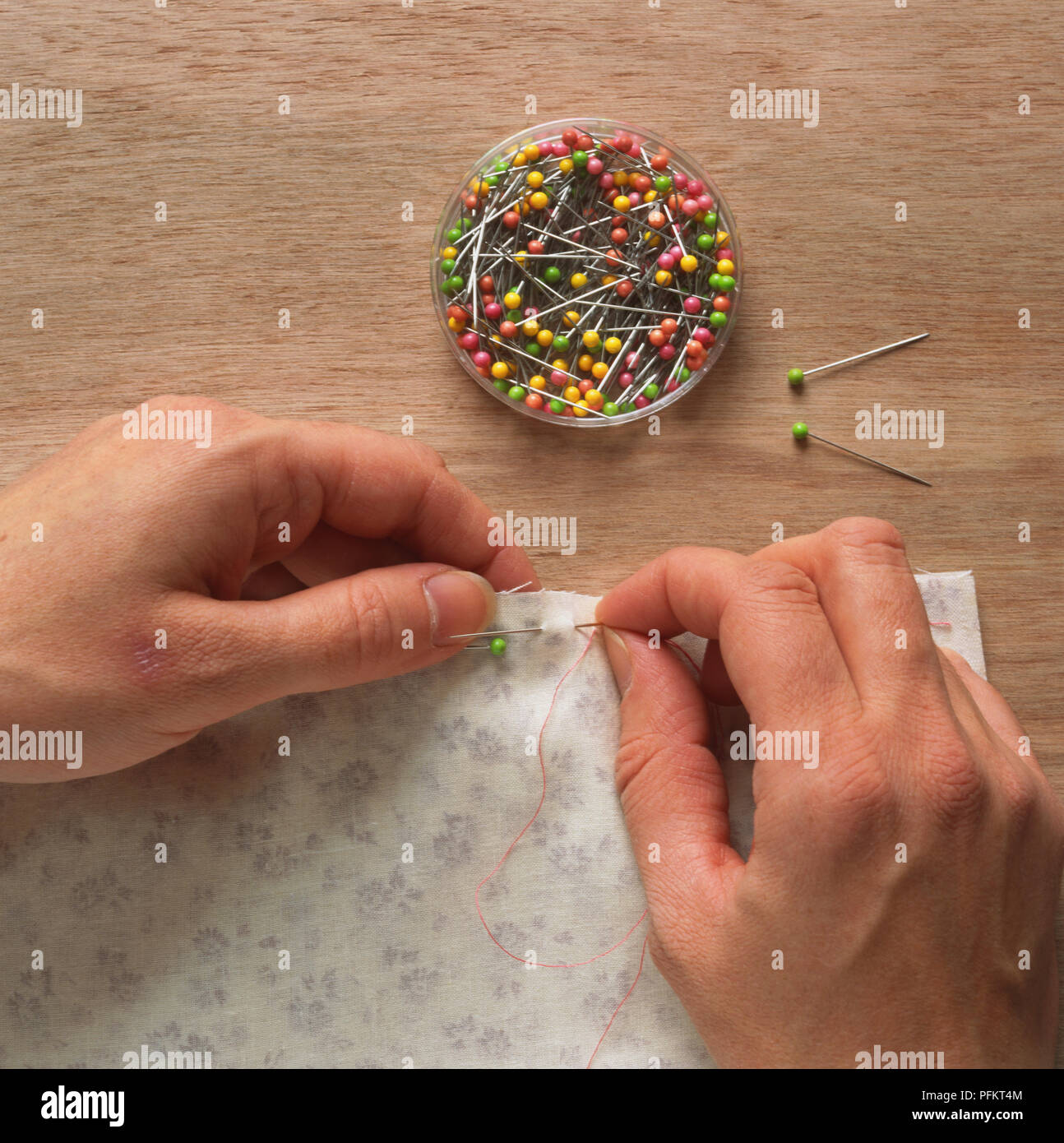 Basting seam with coloured thread and needle Stock Photo - Alamy
