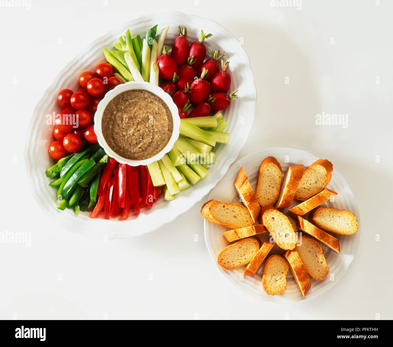 Black olive dip served with crudites and sliced white bread, view from