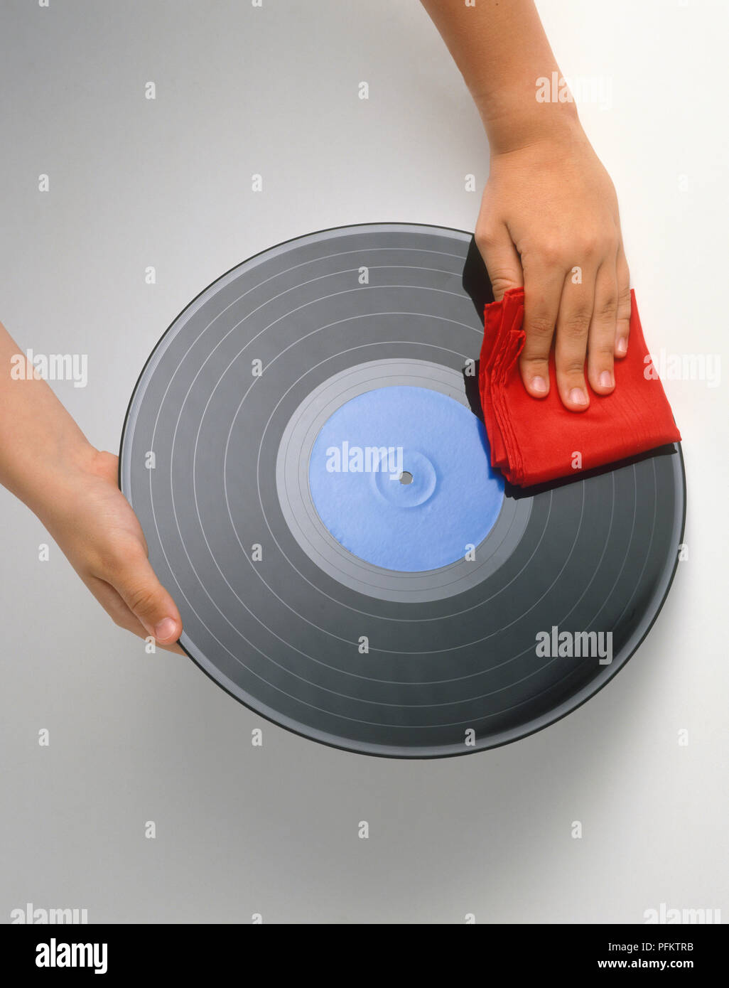 Hand cleaning vinyl record with cloth Stock Photo - Alamy