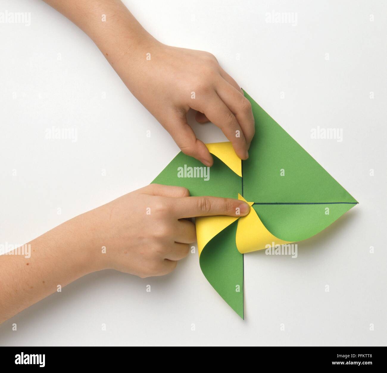 Girls Hand Folding A Paper Windmill Close Up Stock Photo