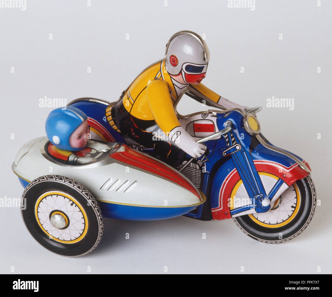 Miniature toy man on a motorbike Stock Photo