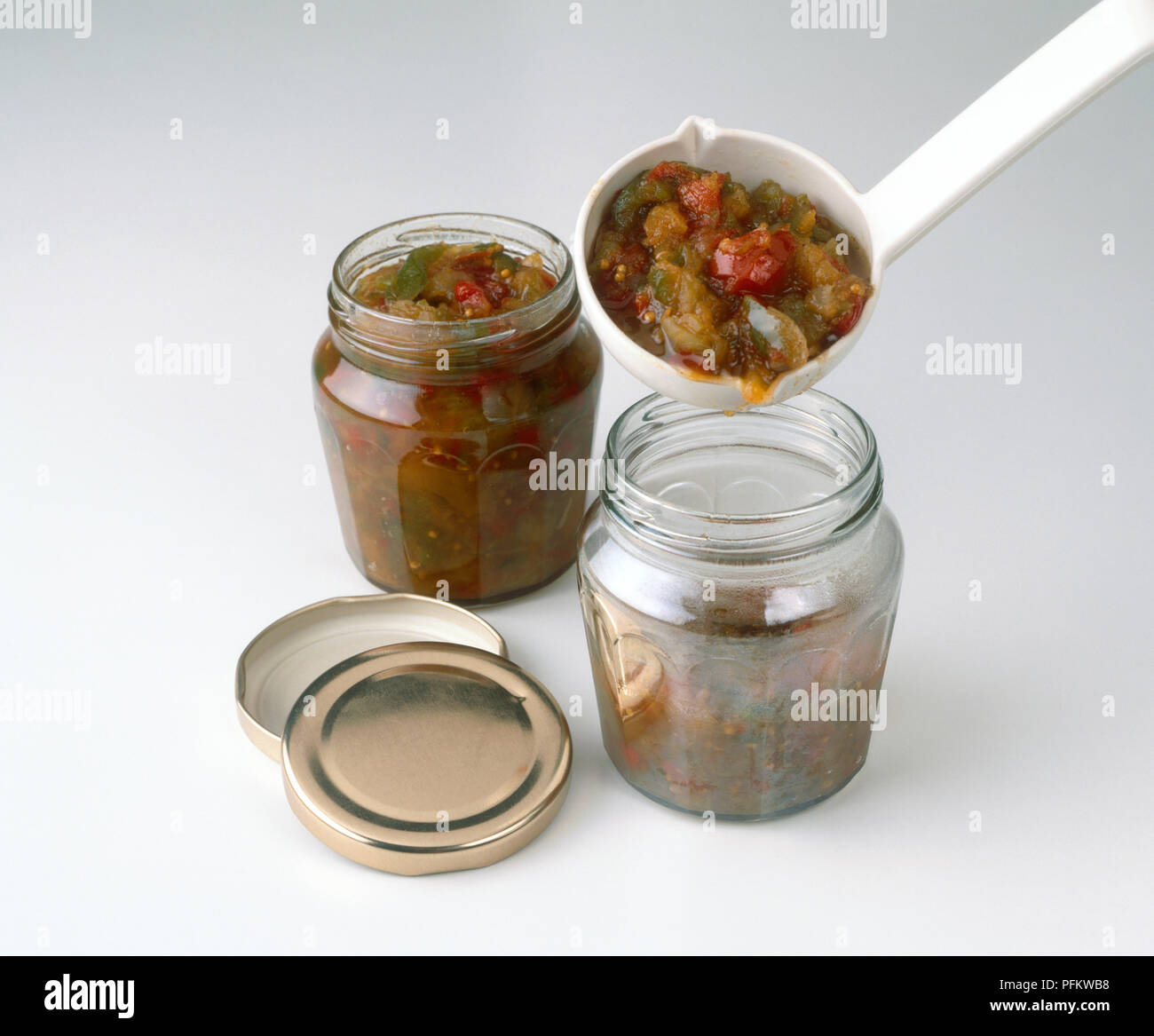 Using ladle to fill jars with piccalilli Stock Photo Alamy
