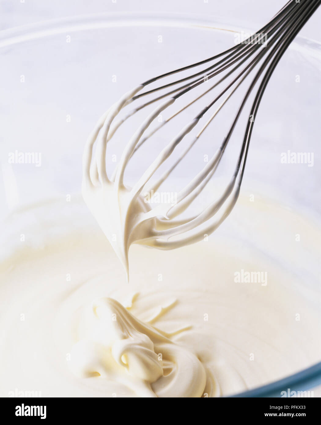Balloon whisk whipping cream to the soft peak stage Stock Photo Alamy