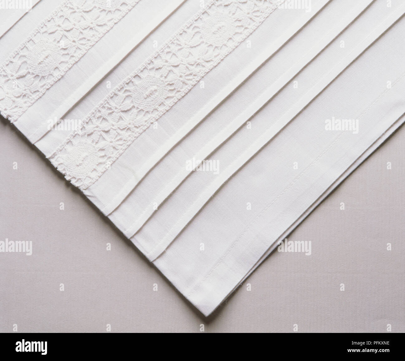 White pillowcase edge with lace and tucks. Stock Photo
