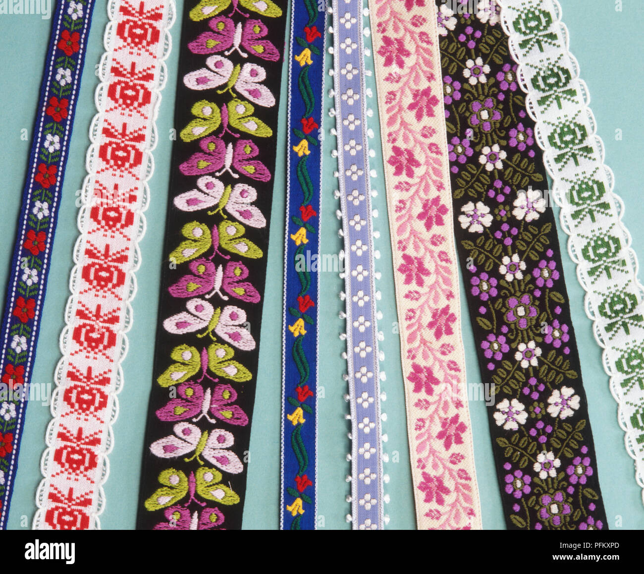 A selection of colourful braids with floral, abstract and butterfly designs on them Stock Photo