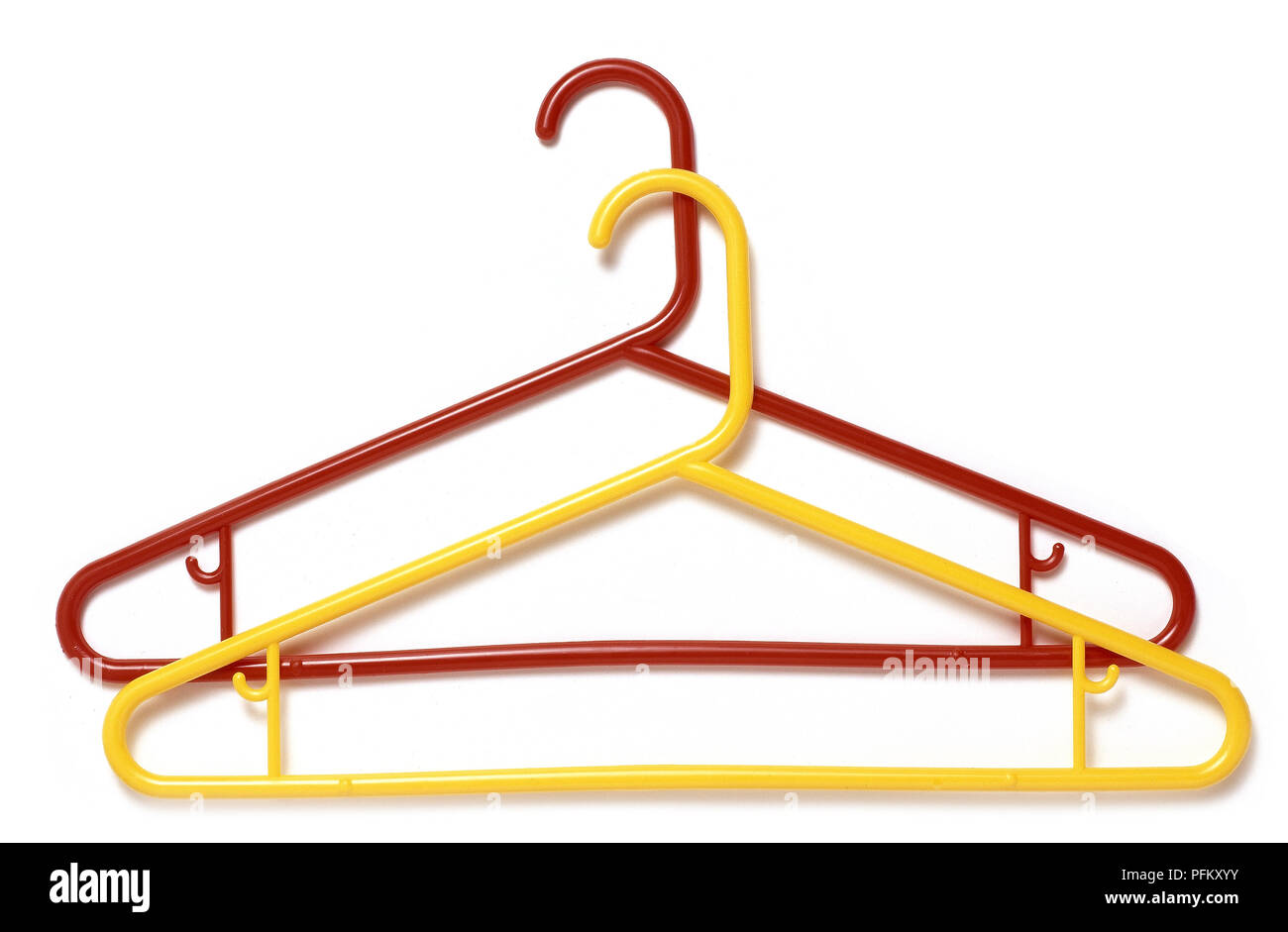 Red and yellow plastic coat hangers, one on top of the other Stock Photo -  Alamy