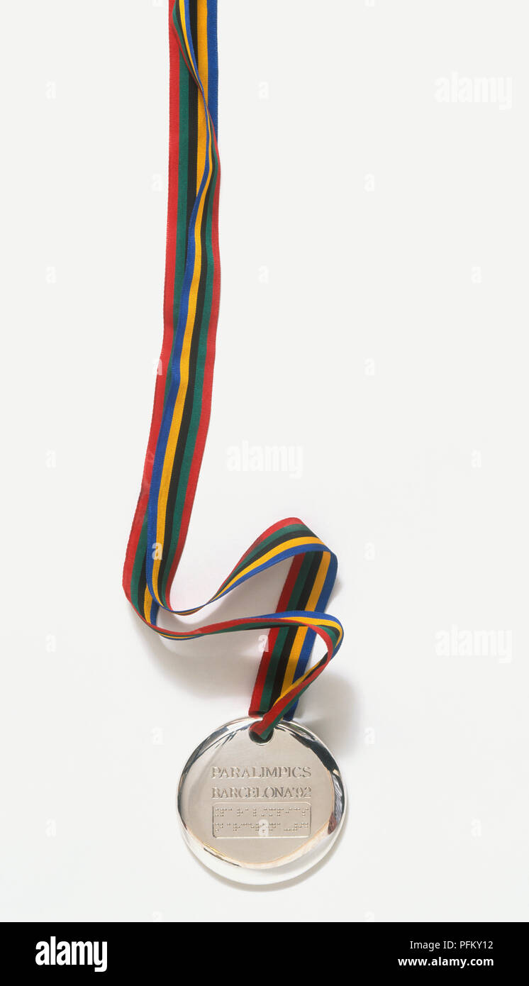 Silver Paralympics medal showing Braille script Stock Photo Alamy