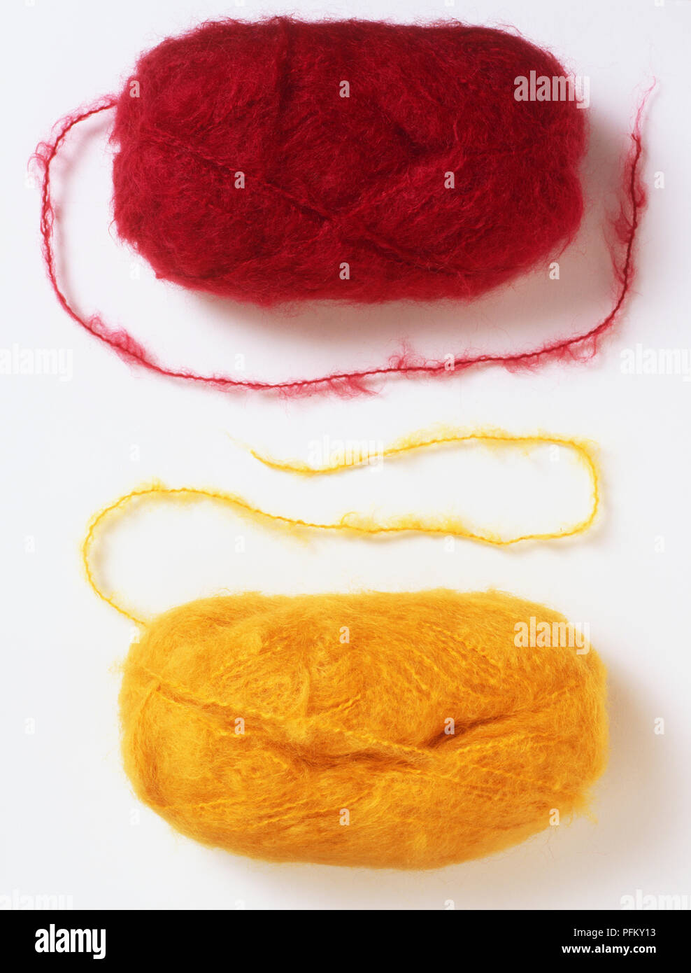 Yellow and red balls of mohair yarn Stock Photo