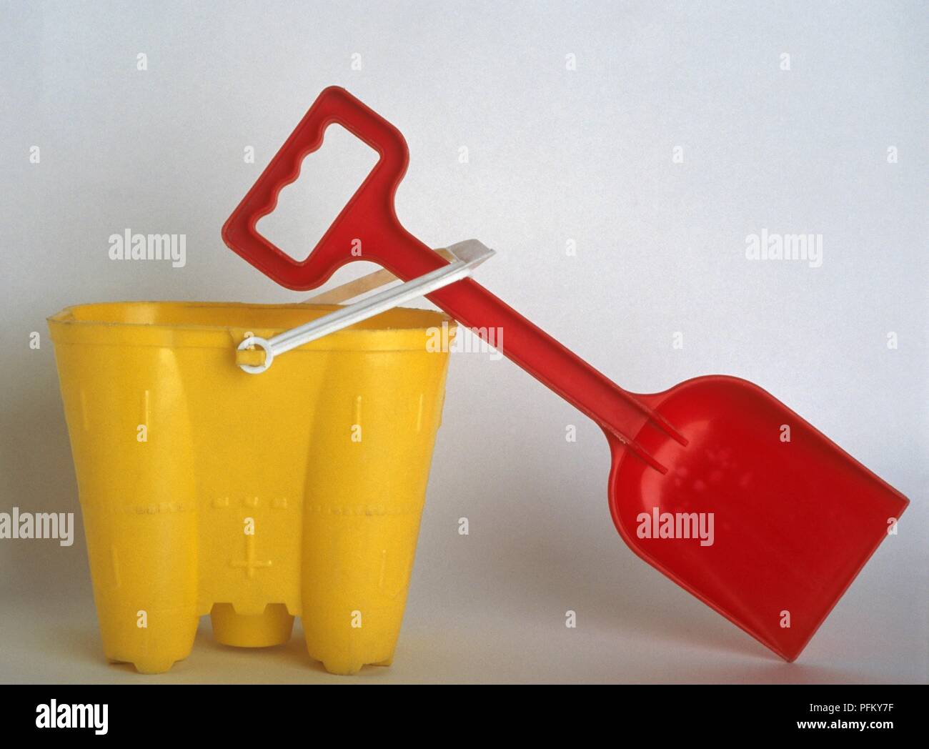 Yellow bucket and red spade Stock Photo Alamy