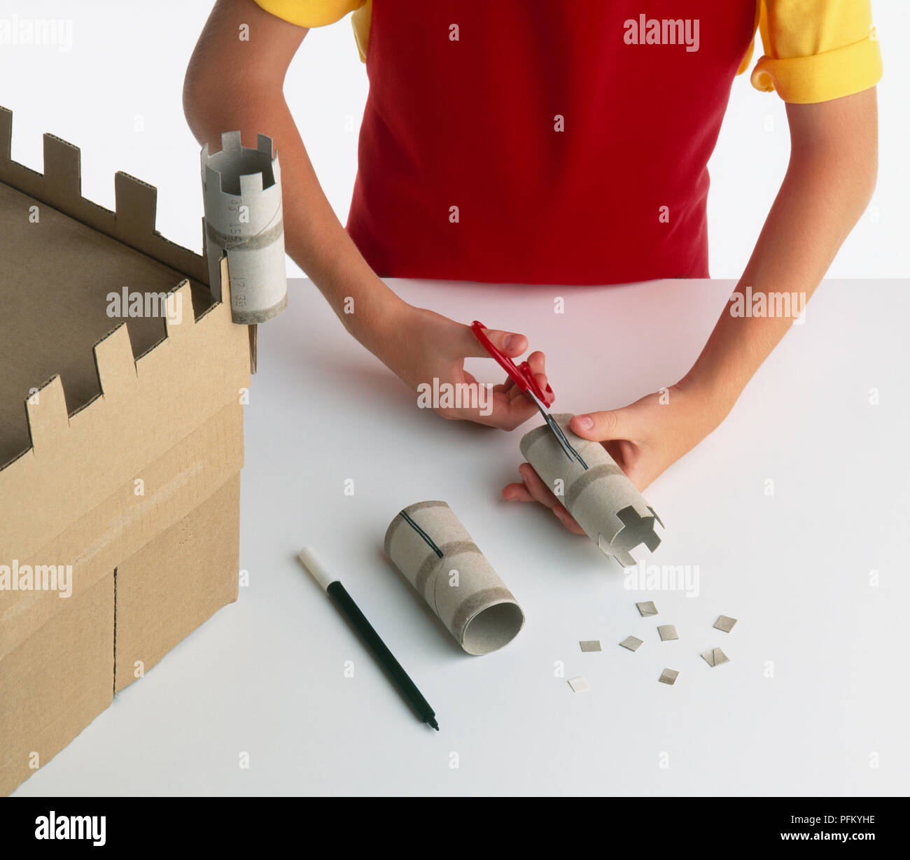 Making Turrets Boy's hand cutting into cardboard tube to make turrets for cardboard ...