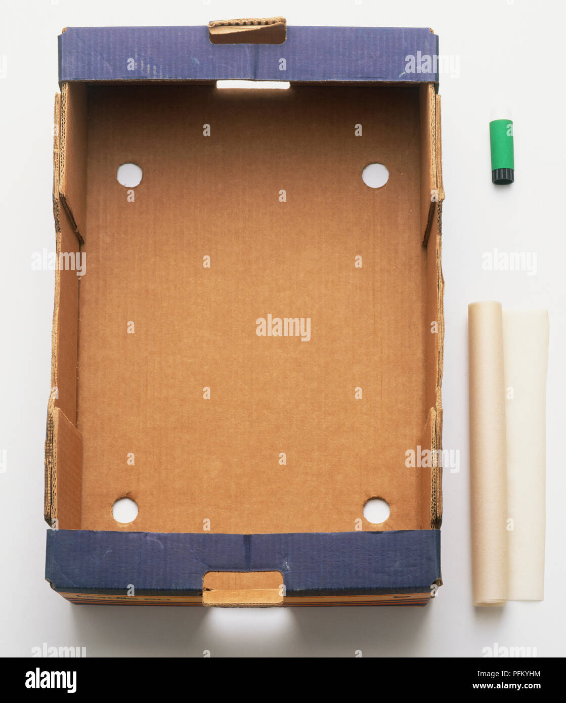 Strong, rectangular cardboard box, roll of paper and glue stick, view from above. Stock Photo