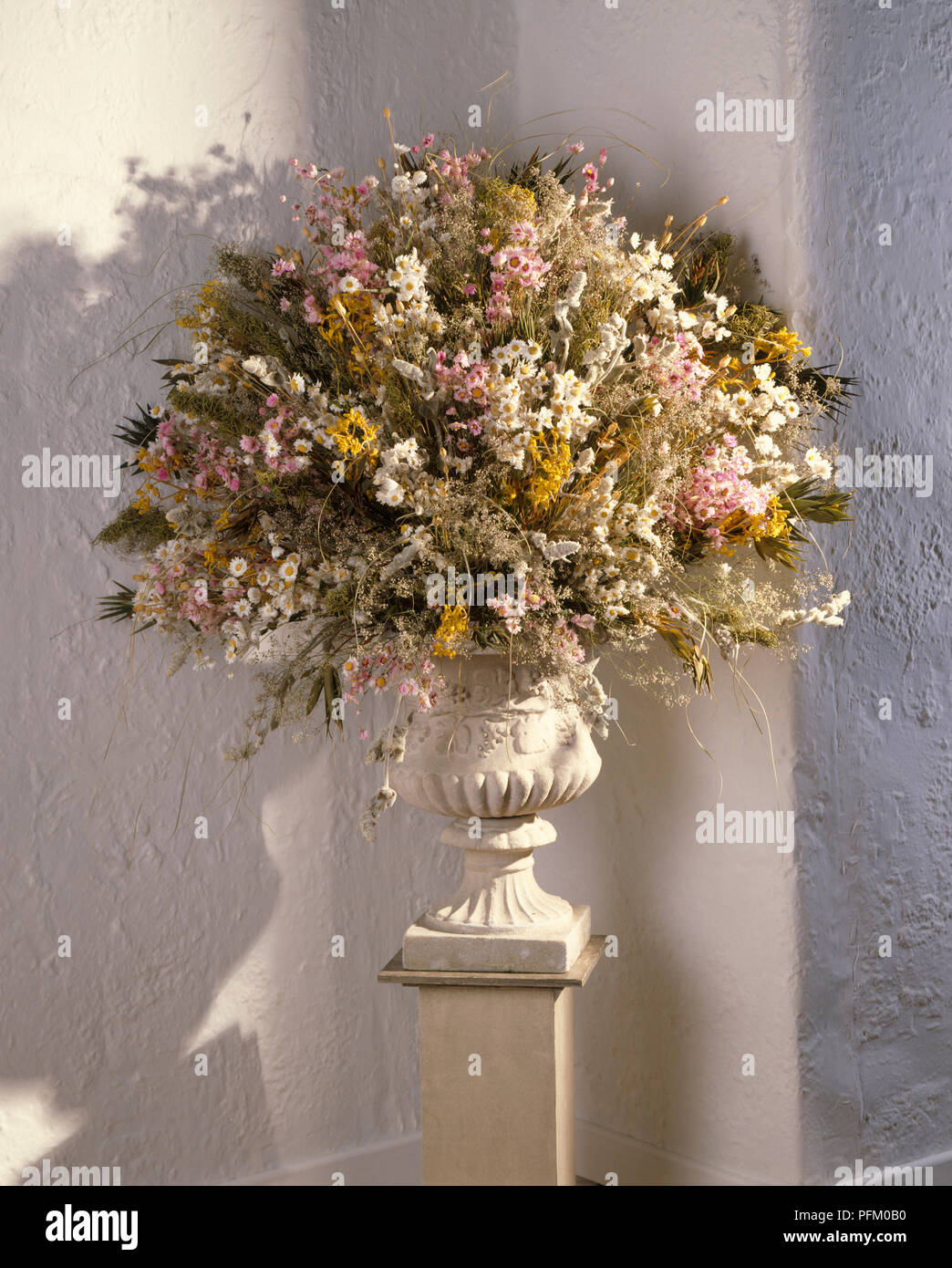 Dried flower arrangement in an urn on a pedestal Stock Photo Alamy