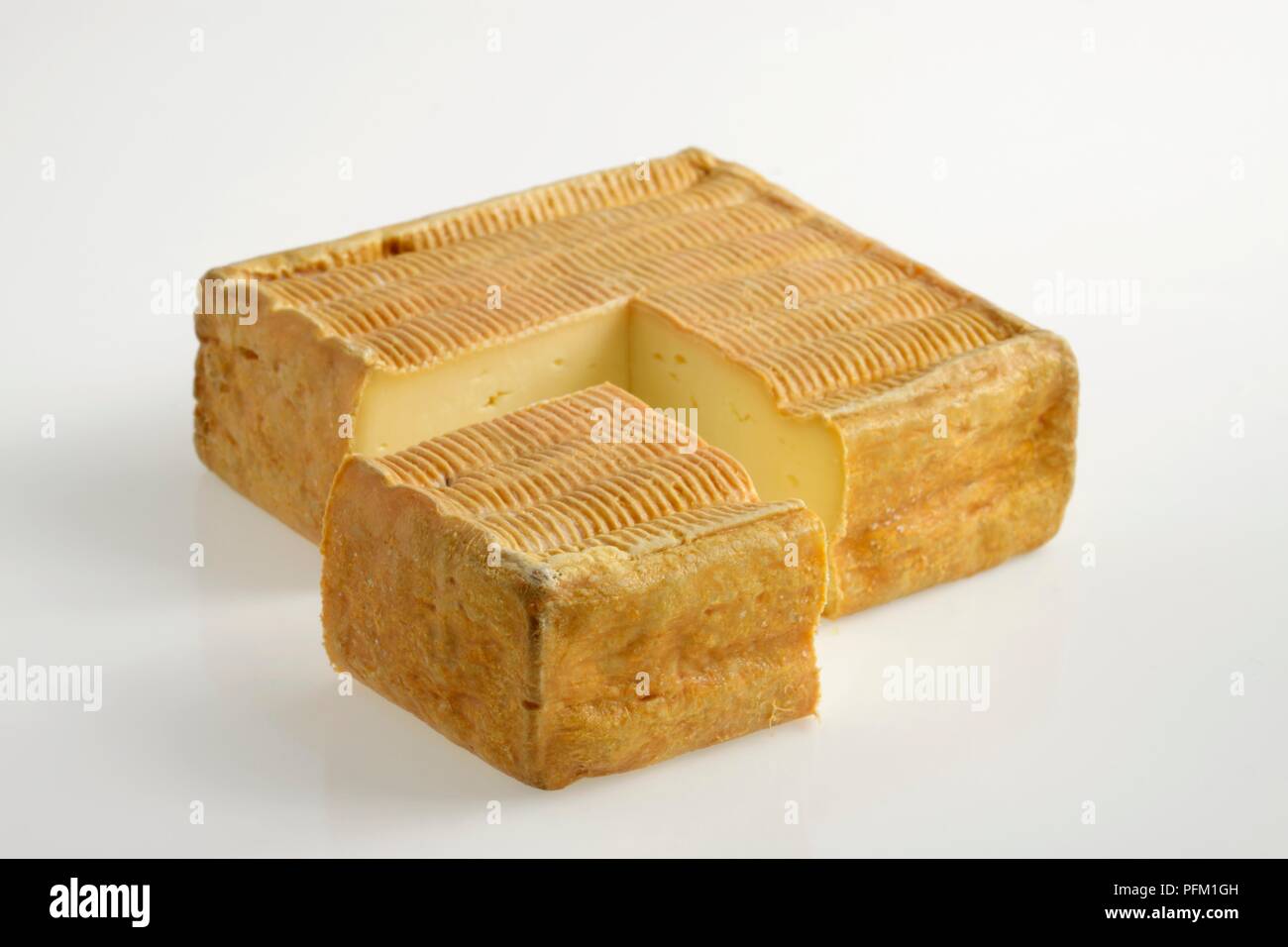 Square and slice of French Maroilles AOC cow's milk cheese distinctive rind Stock Photo