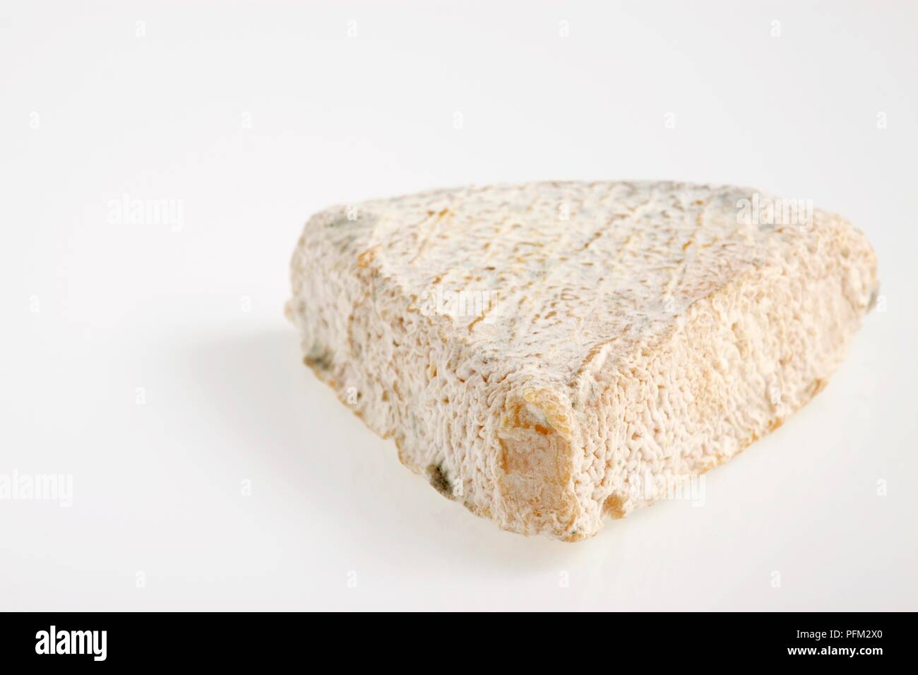 Whole triangle of French Trois Cornes de Vendee goat's cheese Stock Photo